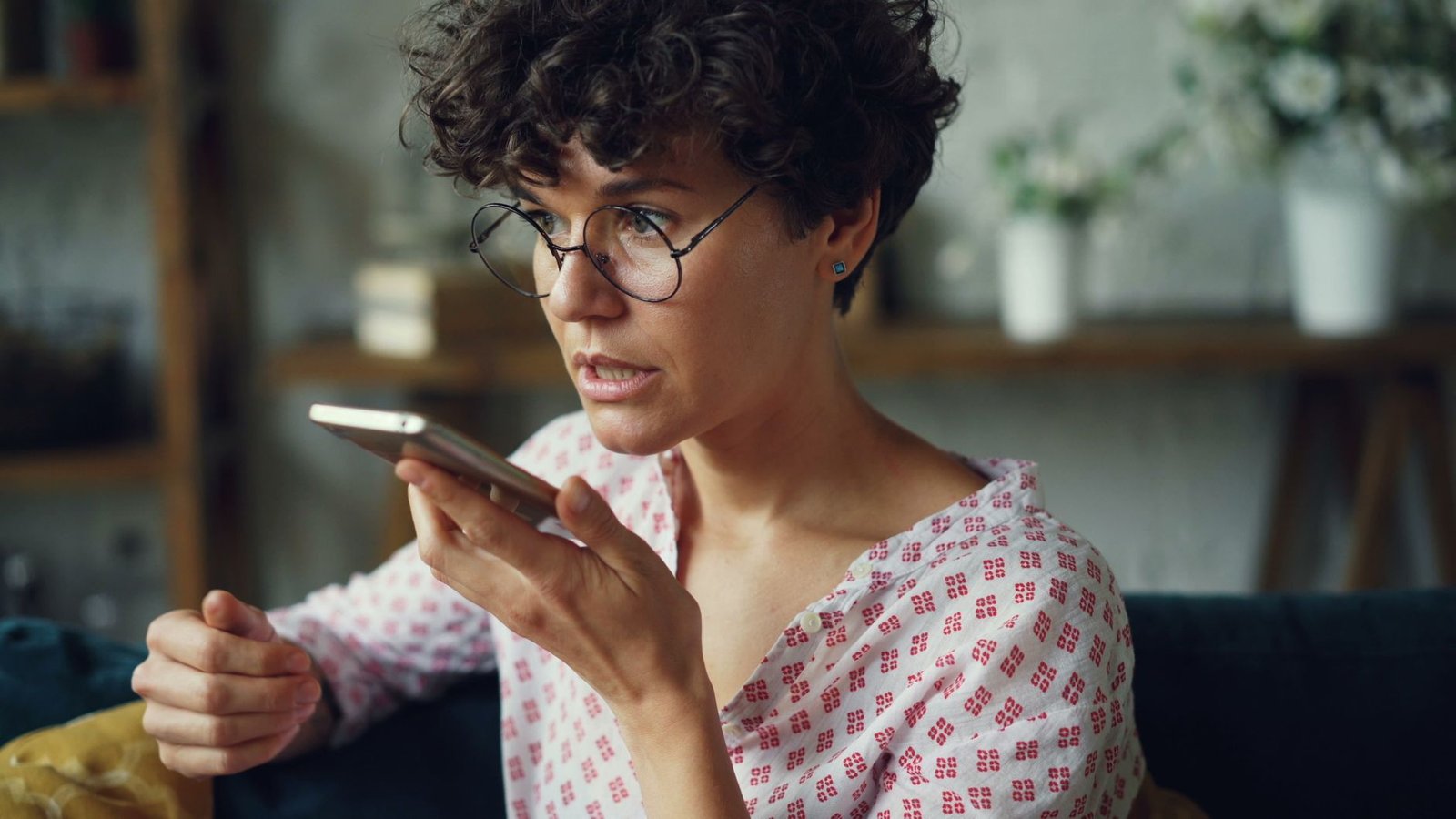 Close up of hands holding a phone recording an audio message