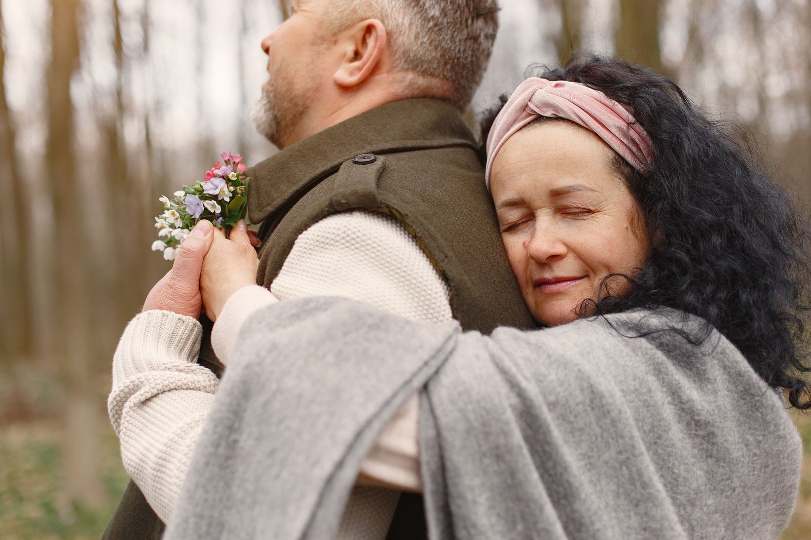 Engaged couple hugging outdoors after a proposal