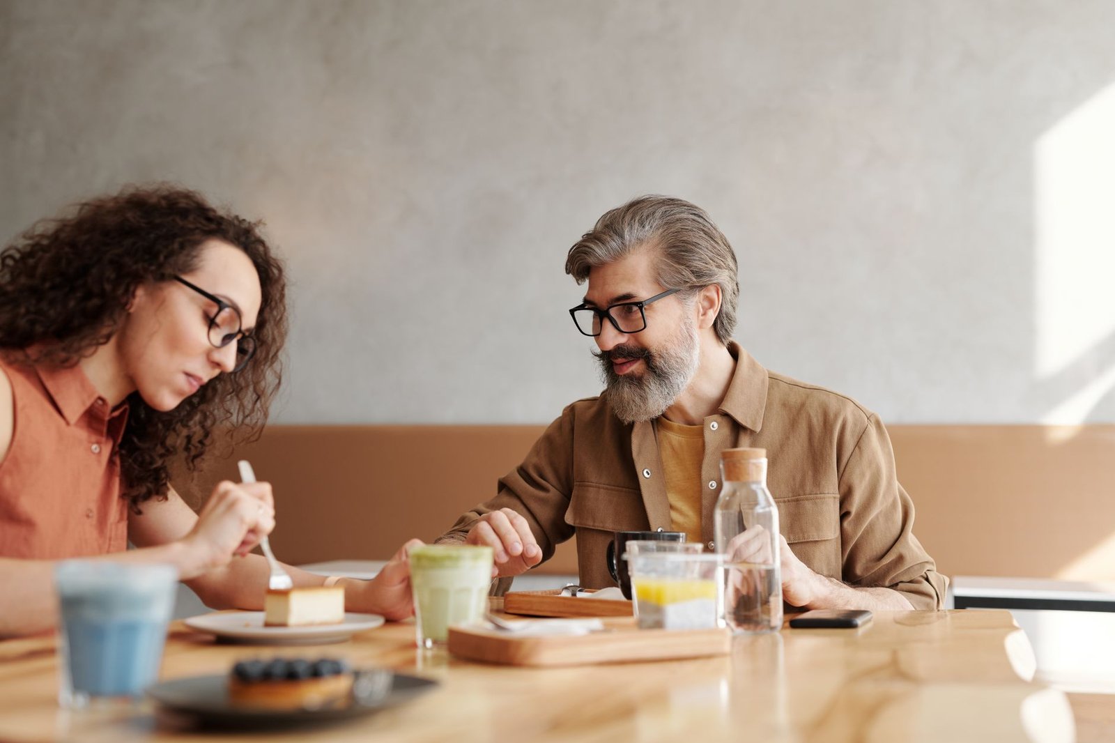 Two friends talking over coffee about a proposal secret