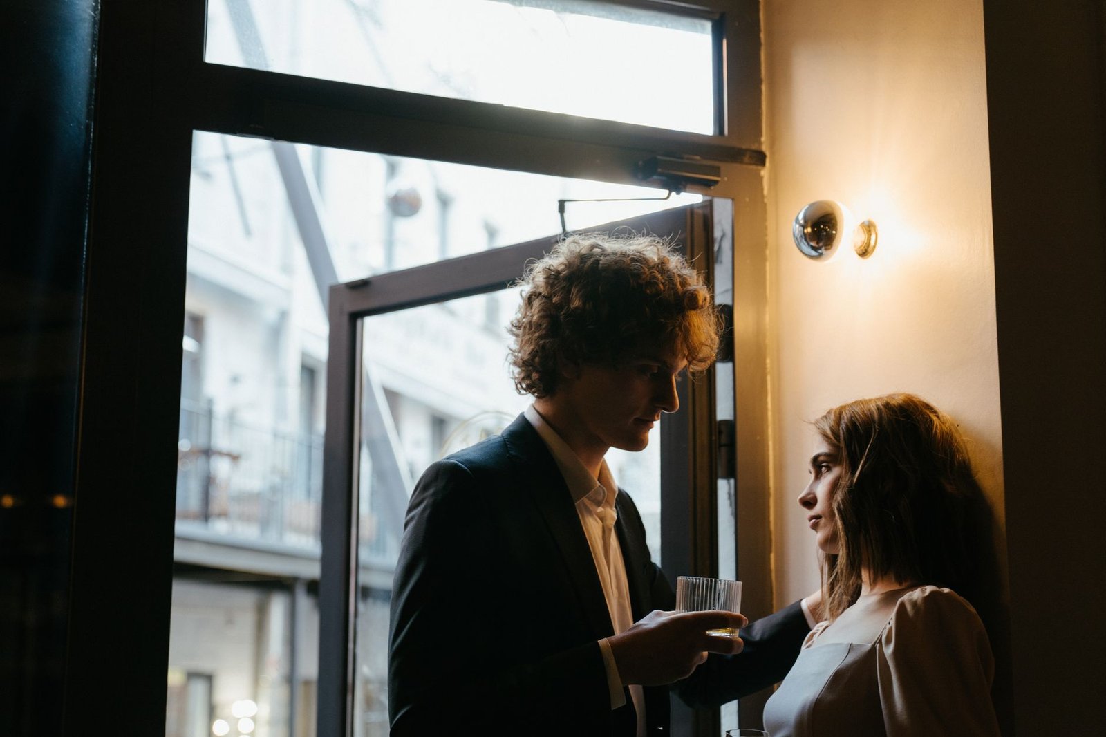 Couple sitting on front steps at night talking honestly, a story about admitting jealousy