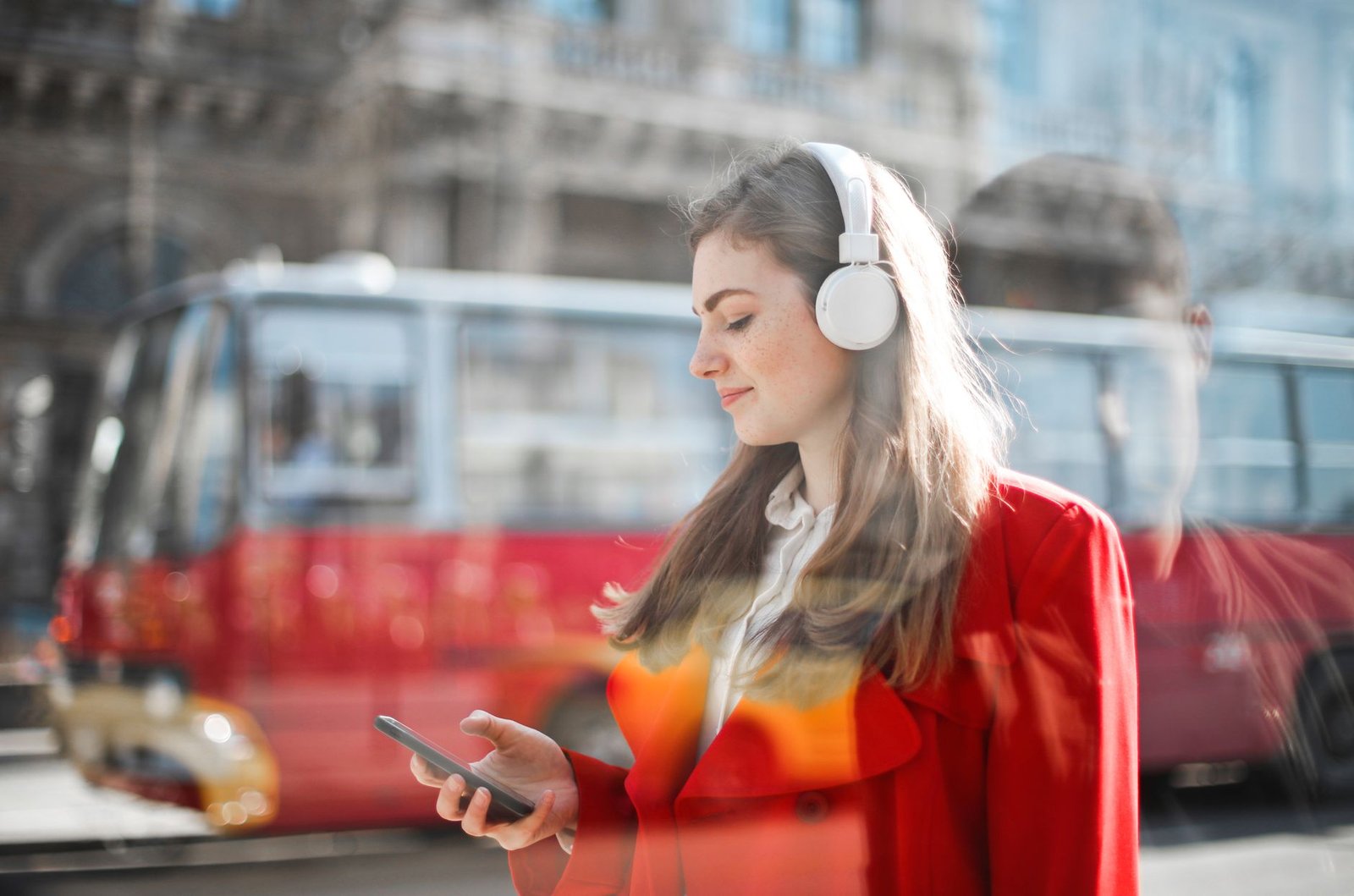 Woman listening to a shared playlist on her phone in the car