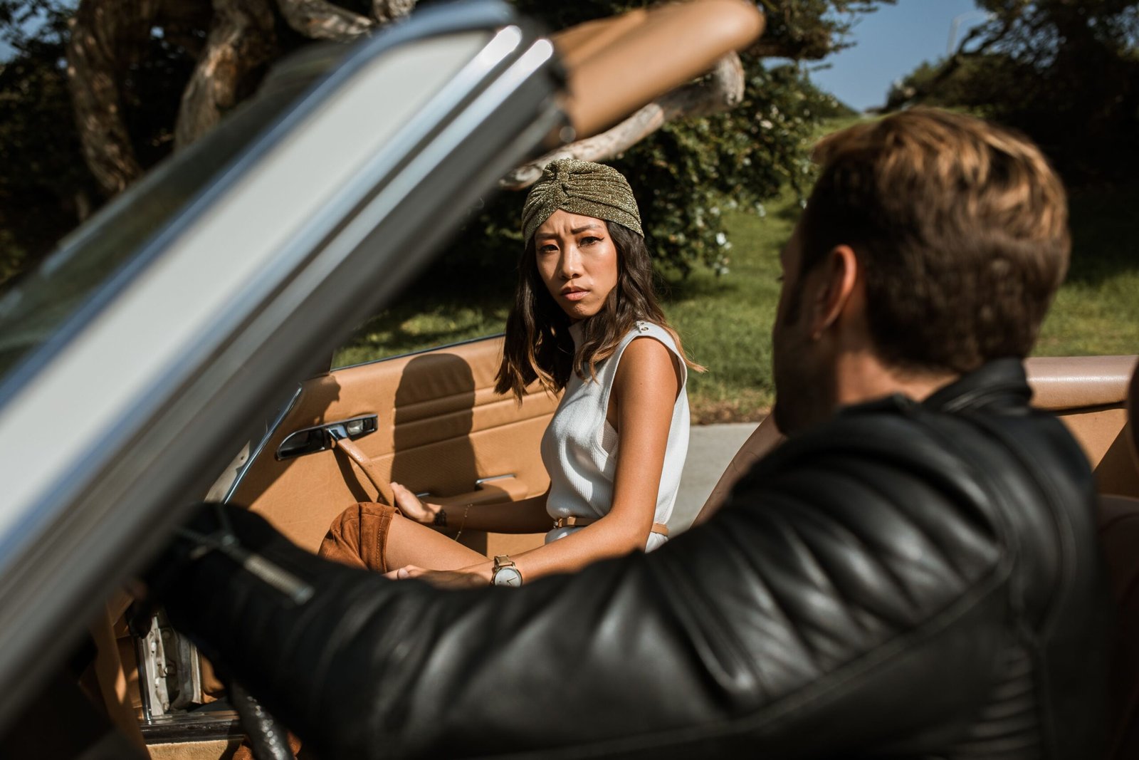 Couple having an intense conversation while seated in a car outdoors