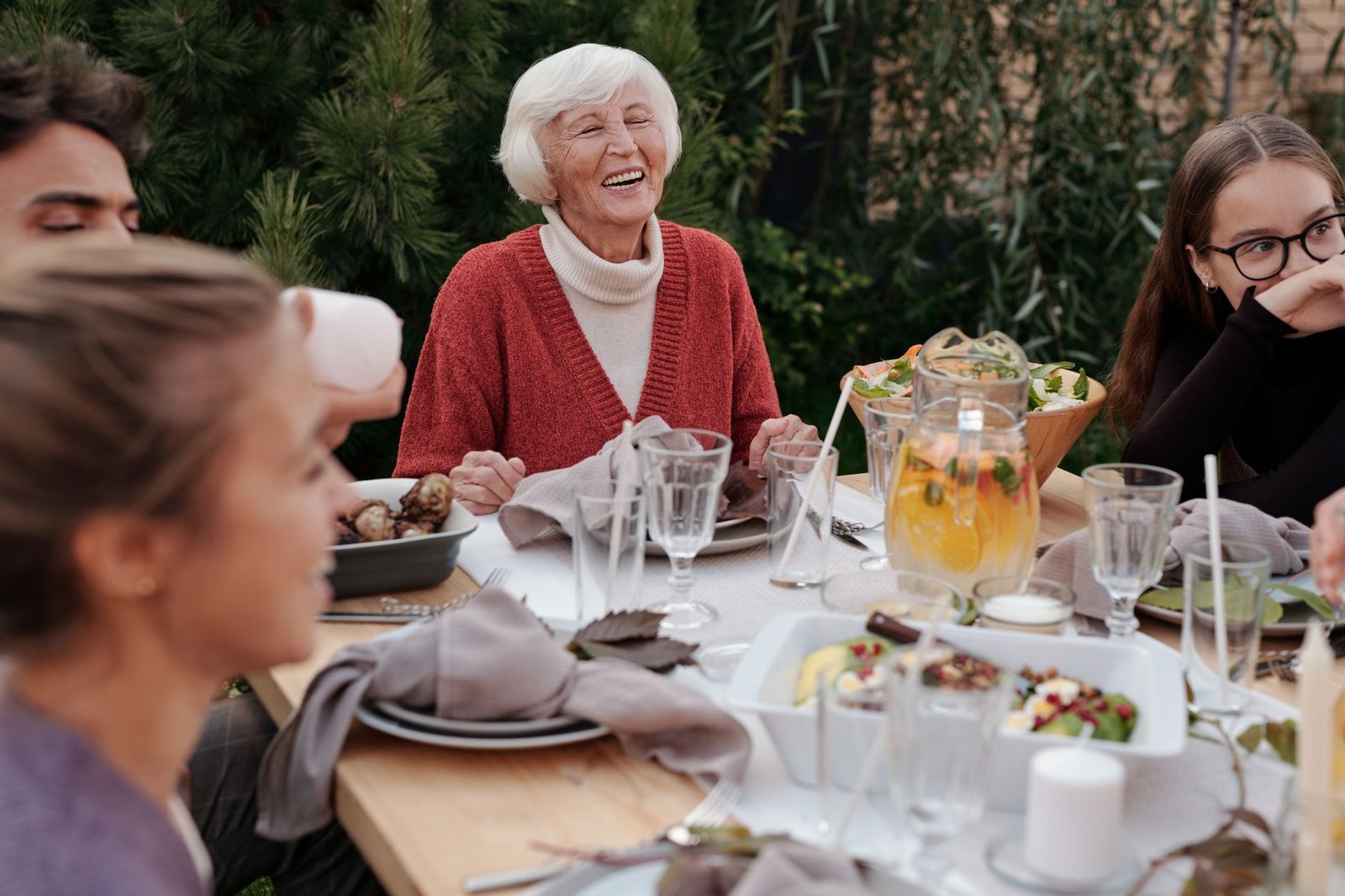 Family laughing together at a Sunday lunch table