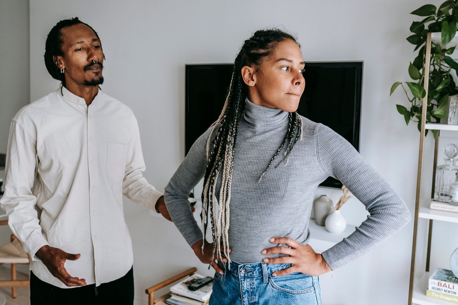 Woman reaching for her boyfriend's hand to ask for a do over