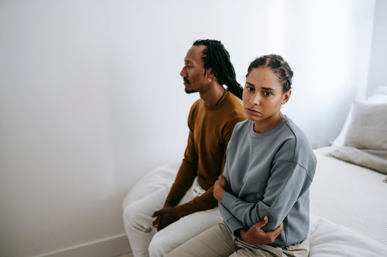 Couple talking seriously across the kitchen table