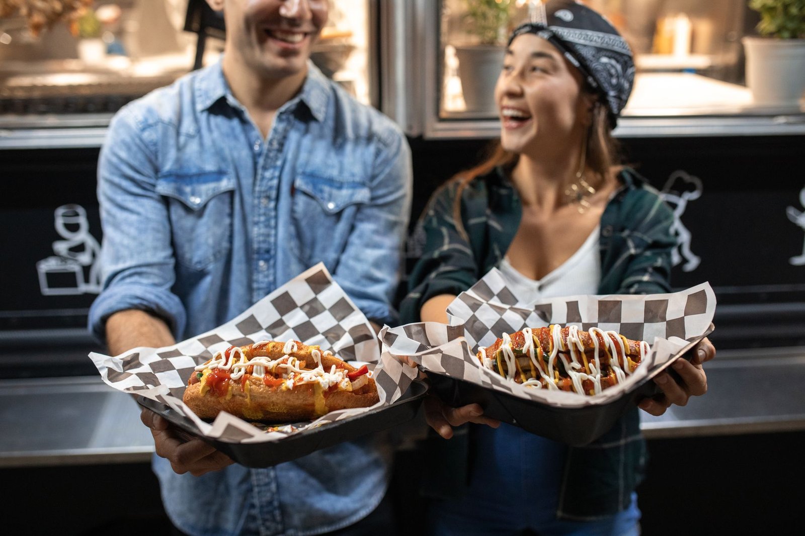 Couple laughing together in line at a taco truck