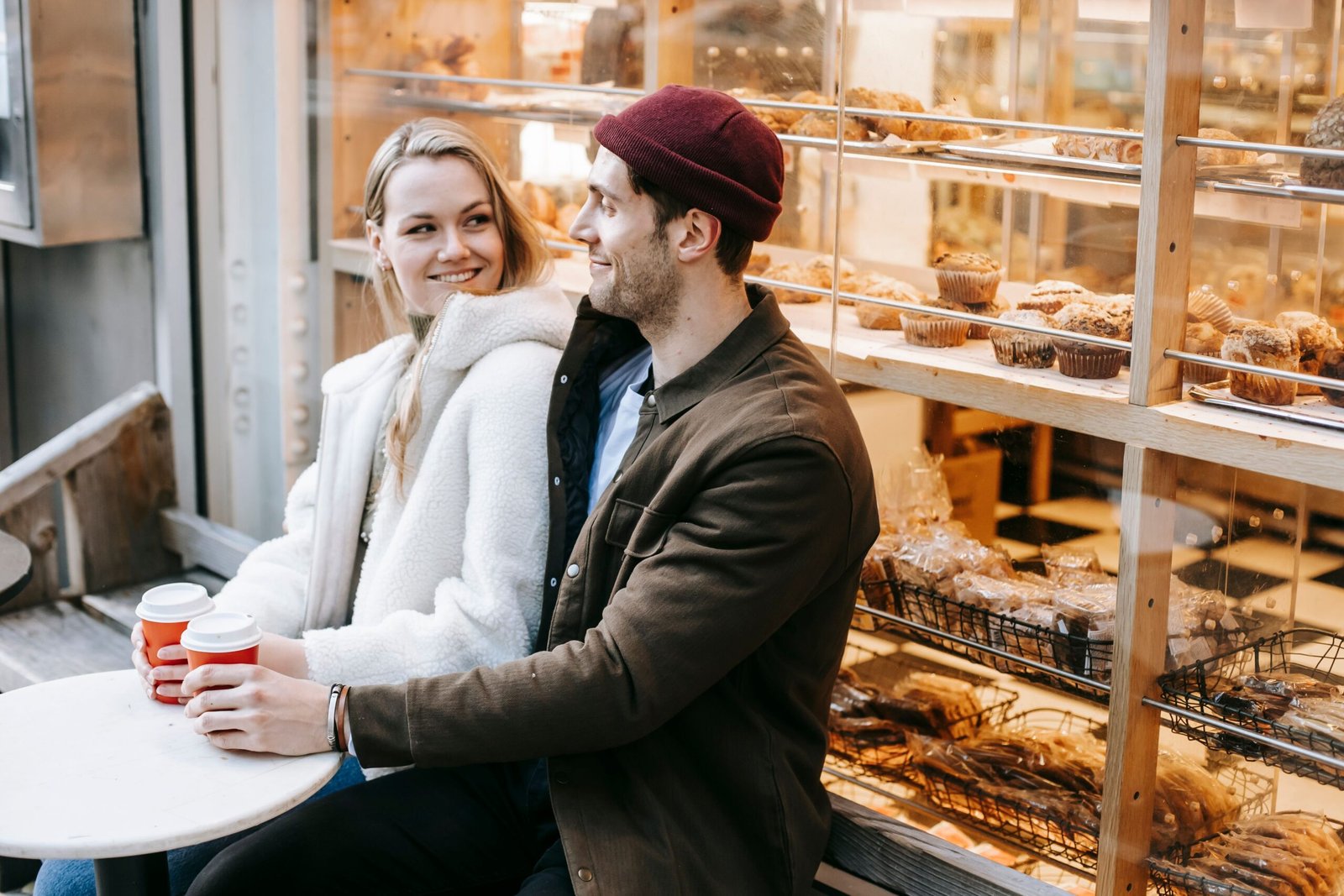 Couple sitting at a cafe table having a first date conversation over coffee