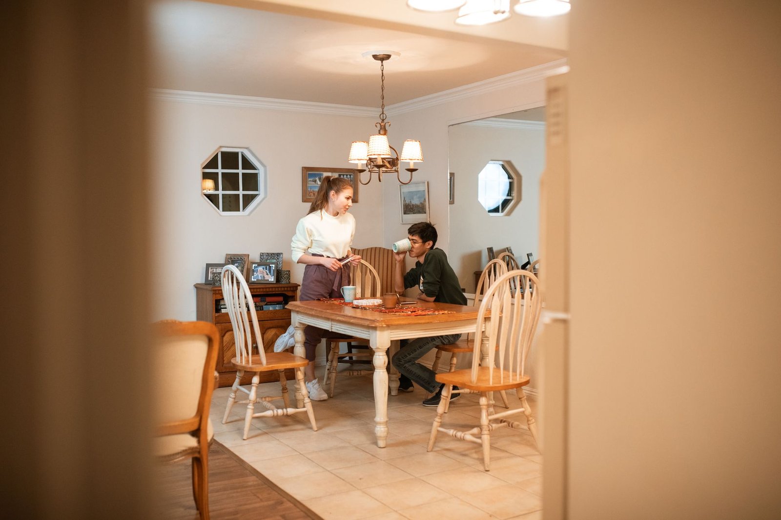 Couple talking seriously at a kitchen table about feedback