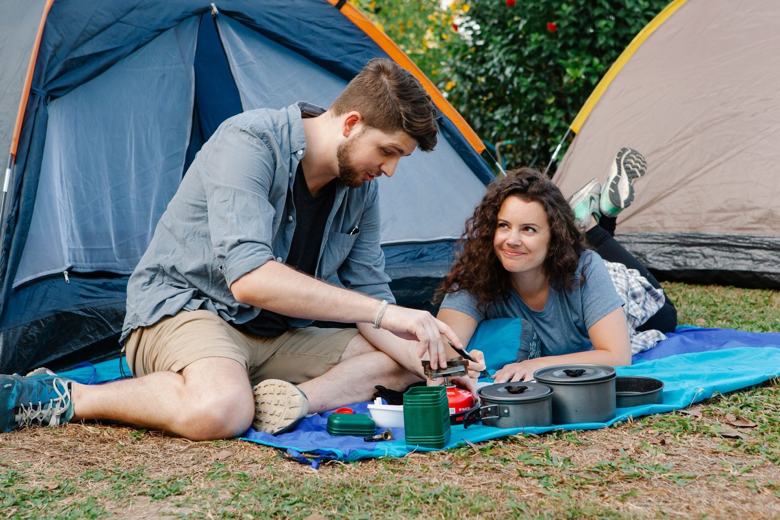 Couple cooking together at a campsite during an anniversary weekend trip