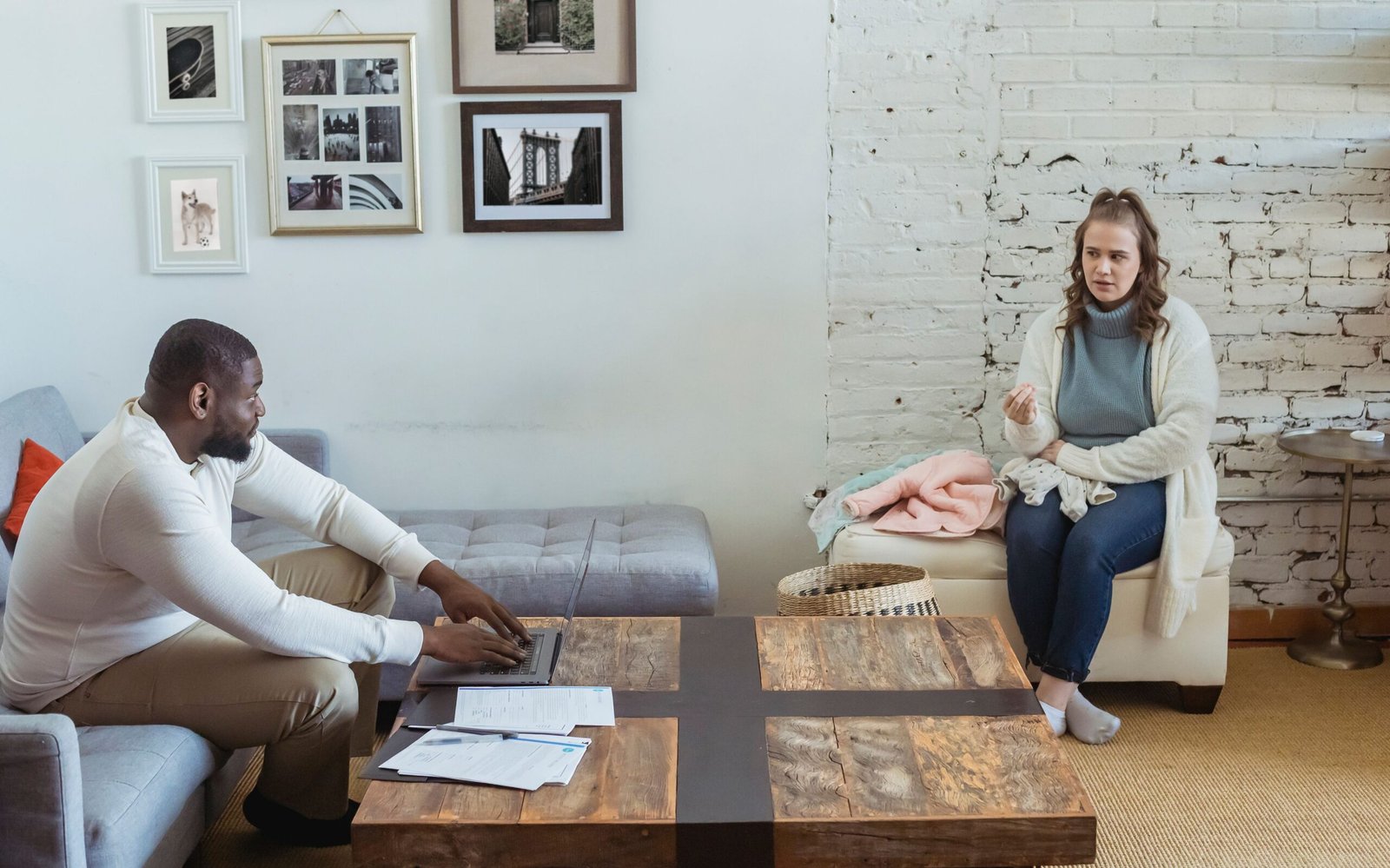 Couple sitting together discussing a tense disagreement at home