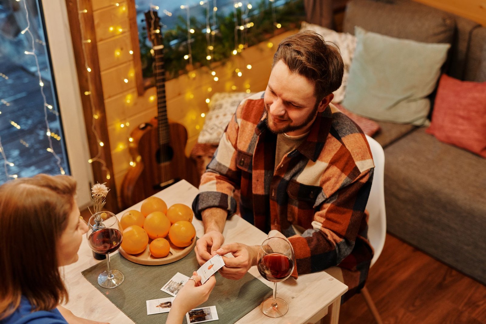 Couple playing cards together during a game night at home
