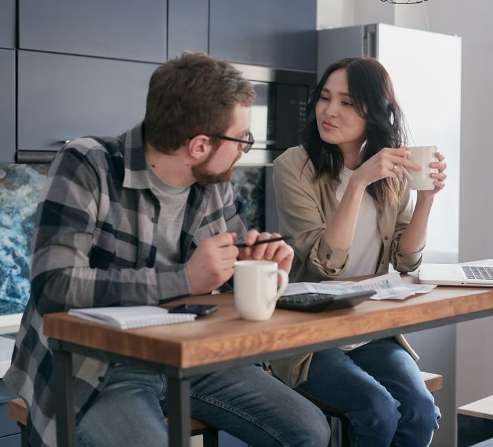 Couple having a serious conversation at their kitchen table