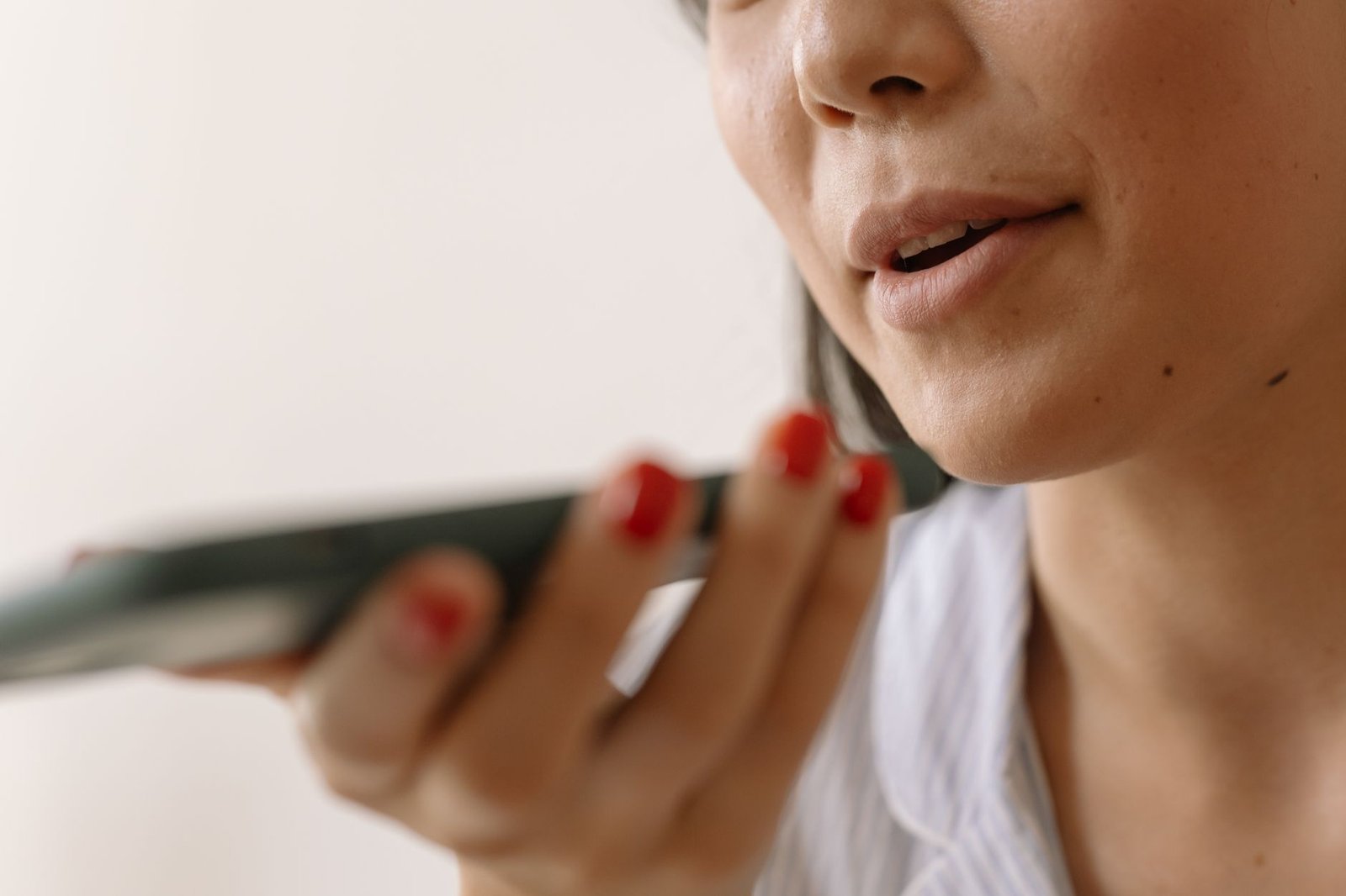 Woman laughing while listening to a voice message from her boyfriend