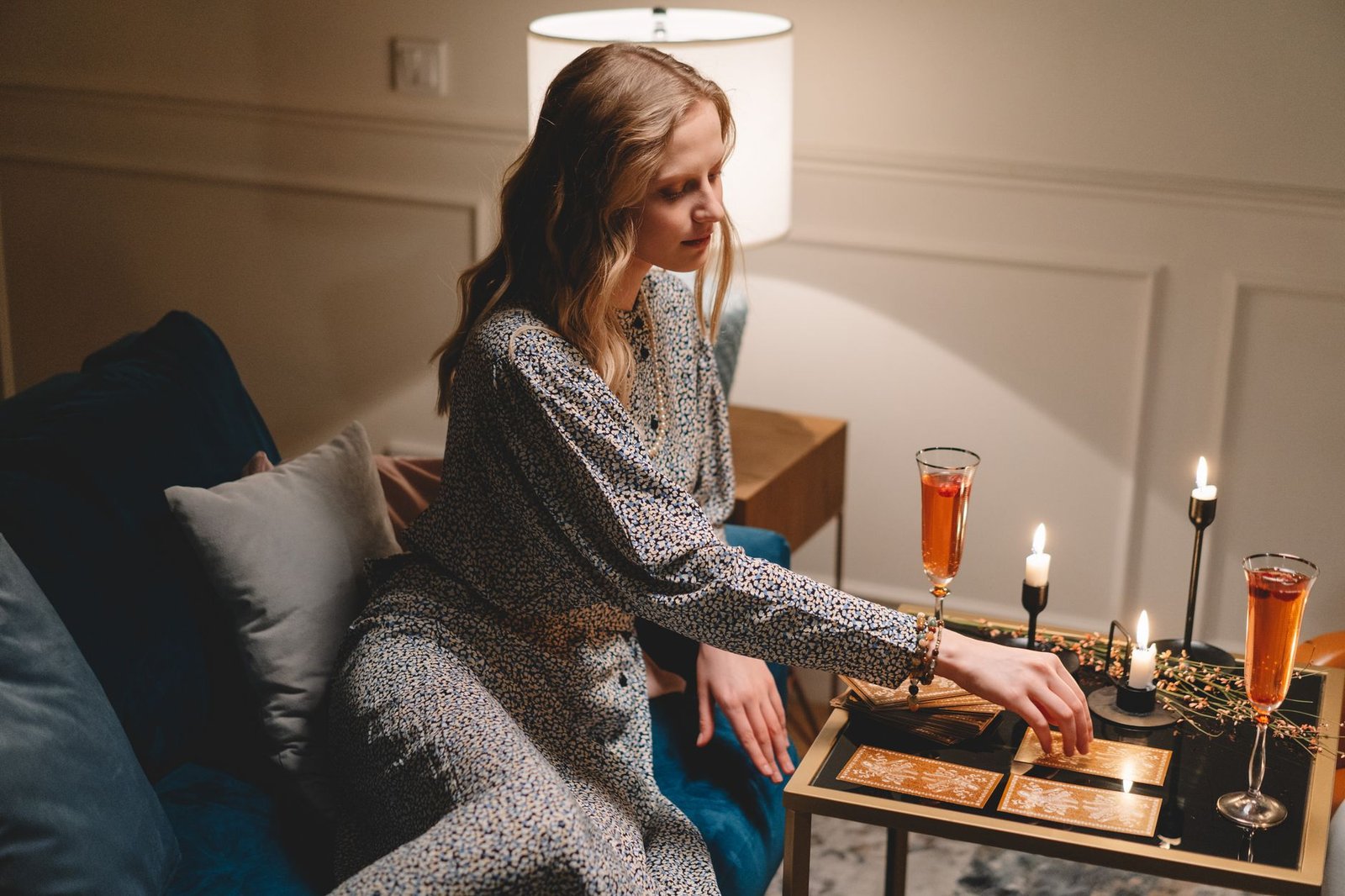 Woman sitting on the couch in the evening checking her phone