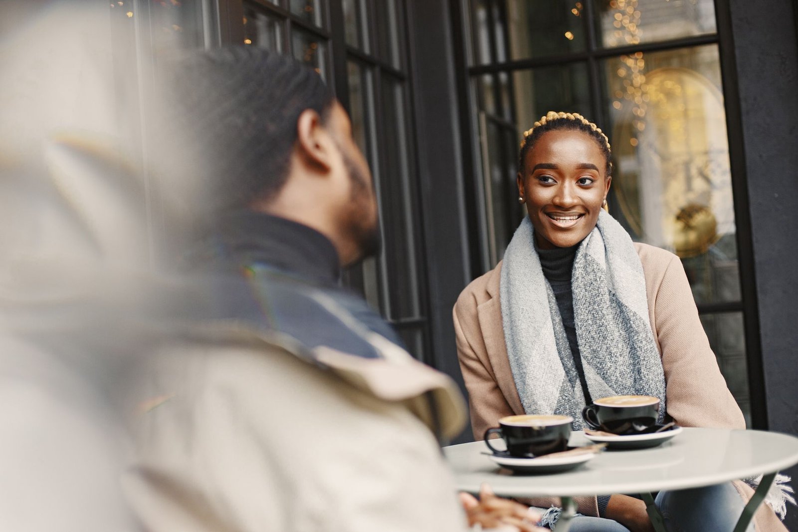 Two friends talking over coffee about a text from an ex
