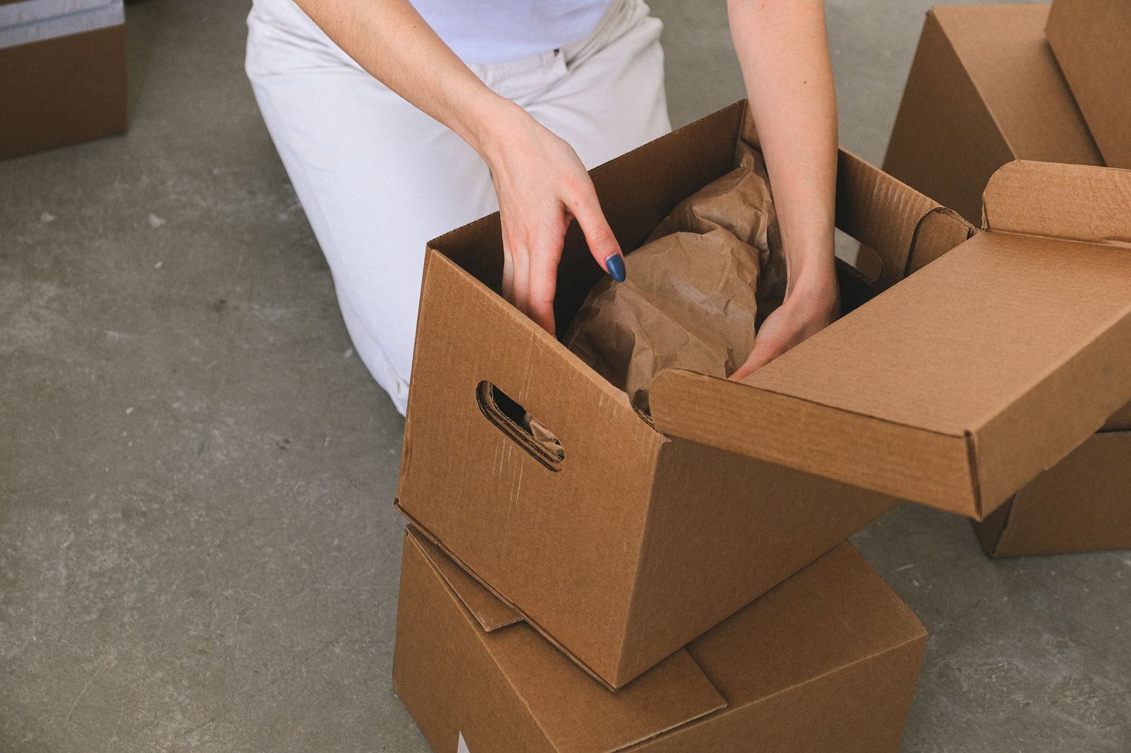 Woman packing moving boxes before a trial stay near her in-laws