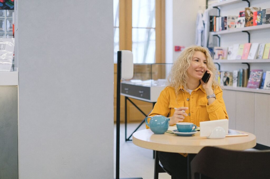 Woman holding her phone outside a cafe feeling unsettled