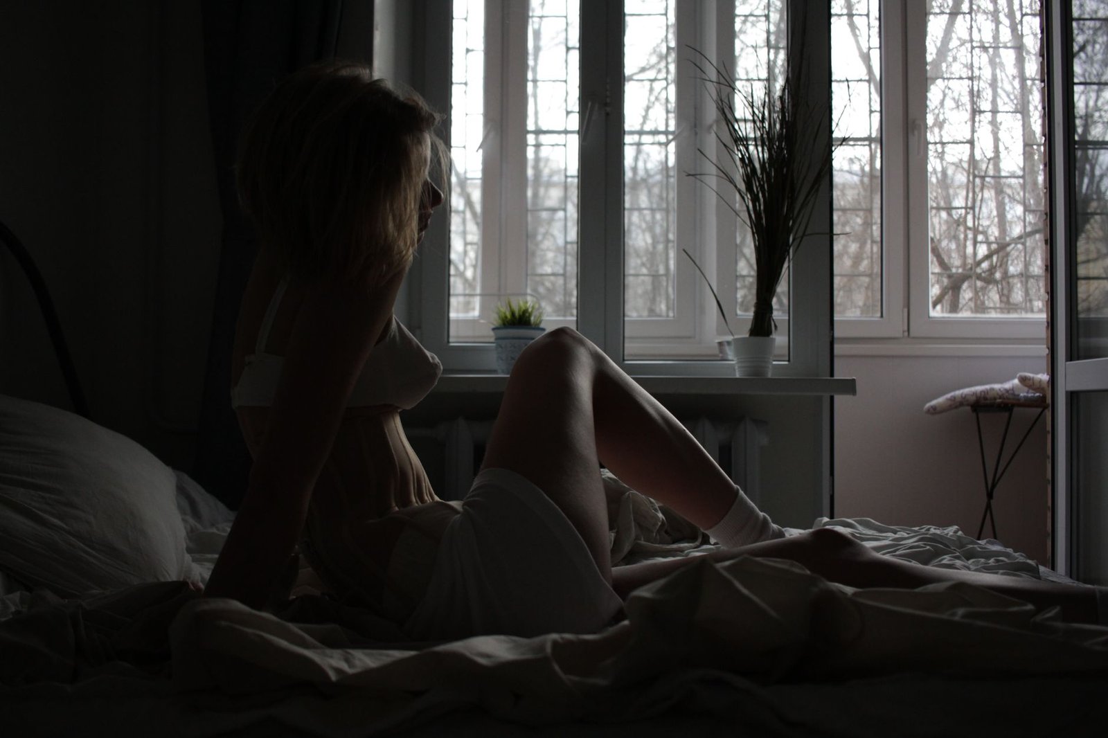 Woman writing in a journal with coffee on an early morning
