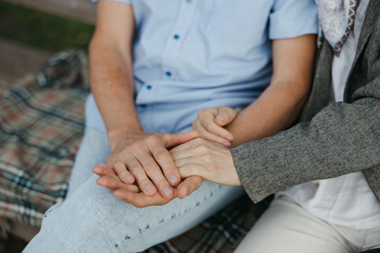 Couple sharing one blanket together on the couch at home