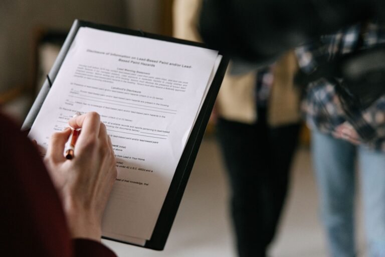 Woman signing a new lease after breakup at a leasing office desk