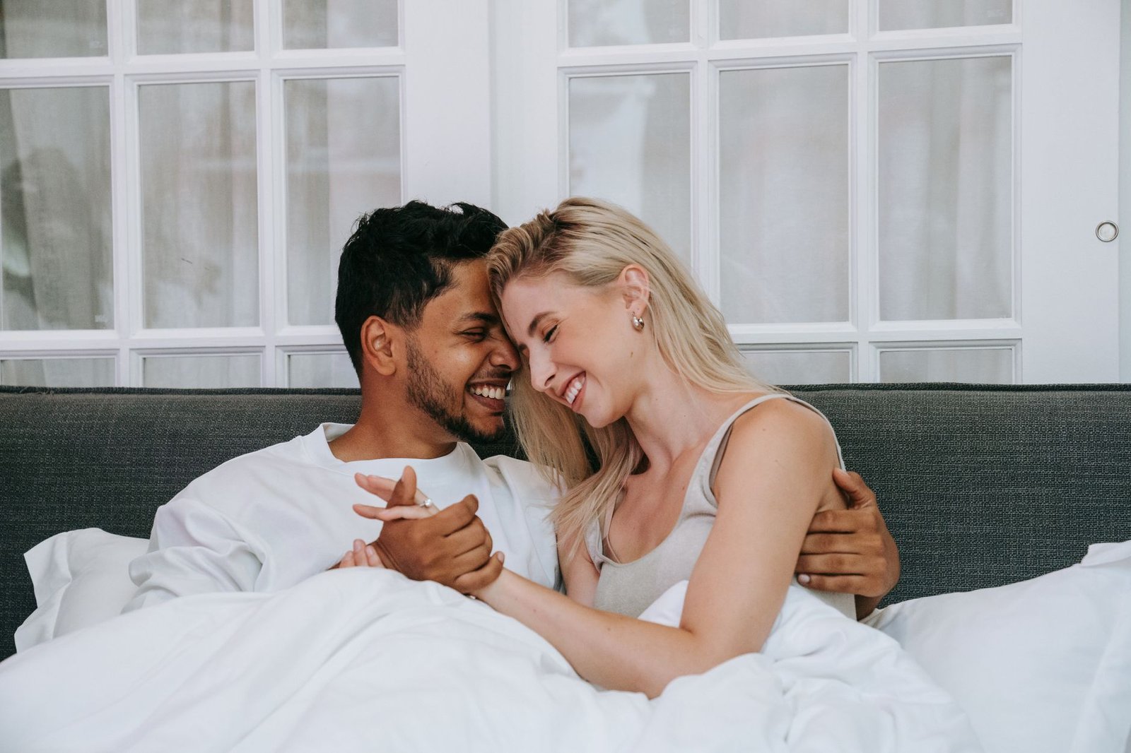 Couple writing a shared grocery list together in their kitchen